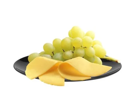 Cheese and ripe grapes on black plate isolated on white Fotos Stock