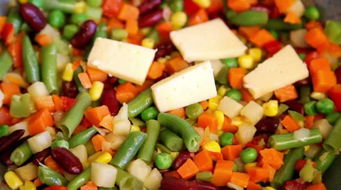 Cheese appearing on vegetable mix Stock Footage 36739406