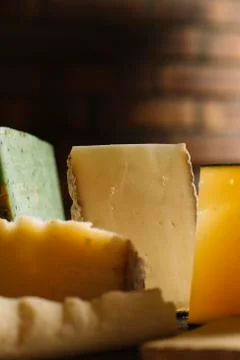Cheese assortment on black background. Various sorts of cheese for appetizing Stock Photos