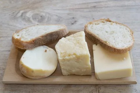 Cheese assortment slices bread tray Stock Photos
