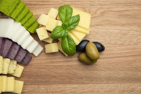 Cheese background. Assortment of different types of cheese on a wooden backgr Stock Photos