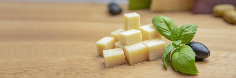 Cheese background. Assortment of different types of cheese on a wooden backgr Stock Photos