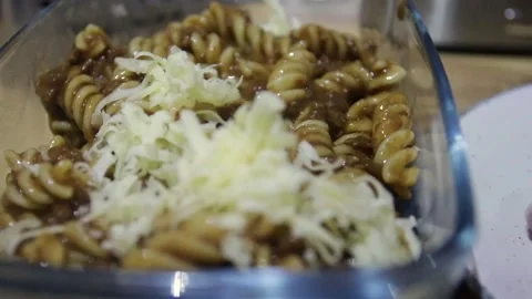 Cheese being added to Pasta Bake Stock Footage 234444304