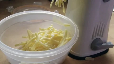 Cheese being Grated with Machine Stock Footage 233351710