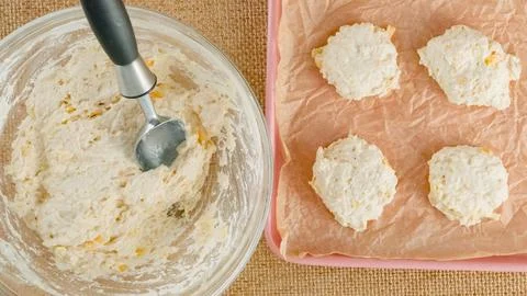 Cheese biscuits recipe, baking process. Scooping biscuit daugh into a bakin.. Stock Photos