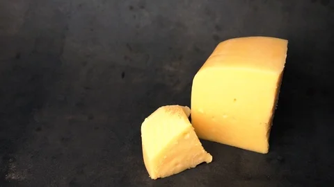Cheese on a black background. pieces of cheese on a black background. Stock Footage 99587140