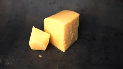 Cheese on a black background. pieces of cheese on a black background. Stock Footage 99587142