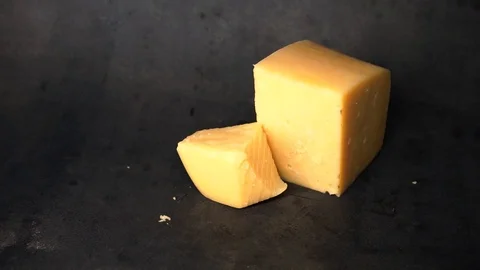 Cheese on a black background. pieces of cheese on a black background. Stock Footage 99587148
