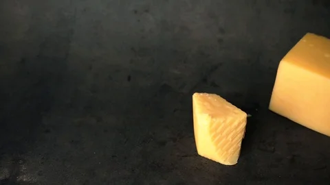 Cheese on a black background. pieces of cheese on a black background. Stock Footage 99587164