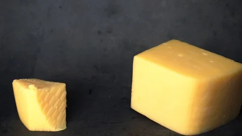 Cheese on a black background. pieces of cheese on a black background. Stock Footage 99587171