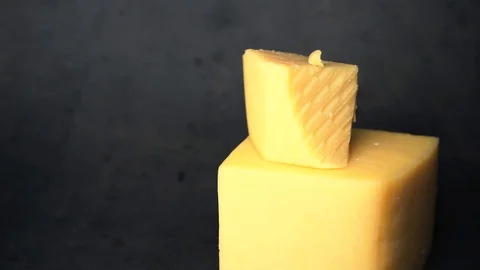 Cheese on a black background. pieces of cheese on a black background. Stock Footage 99587172