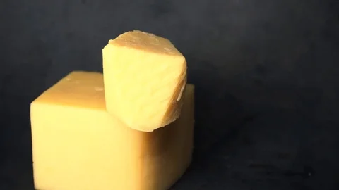 Cheese on a black background. pieces of cheese on a black background. Stock Footage 99587182