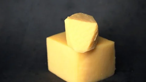 Cheese on a black background. pieces of cheese on a black background. Stock Footage 99587187