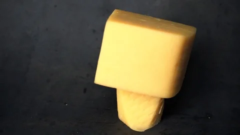 Cheese on a black background. pieces of cheese on a black background. Stock Footage 99587190