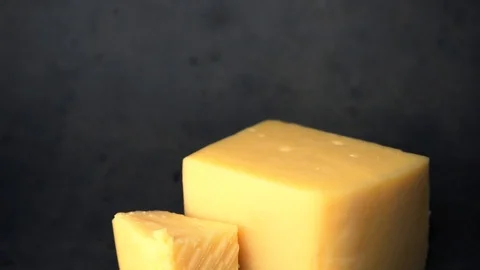 Cheese on a black background. pieces of cheese on a black background. Stock Footage 99587209
