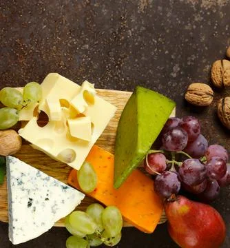 Cheese board assorted cheeses for appetizers Stock Photos
