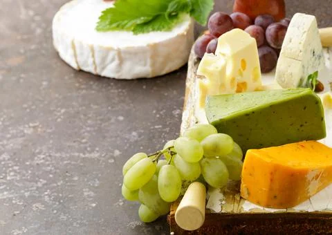 Cheese board assorted cheeses for appetizers Stock Photos
