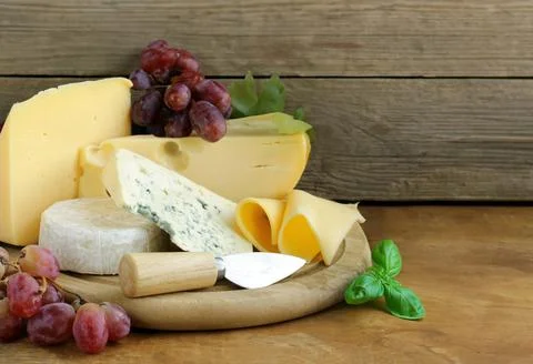 Cheese board assorted cheeses for appetizers Stock Photos