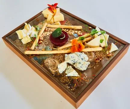 Cheese board featuring blue cheese, brie, and hard cheeses Stock Photos