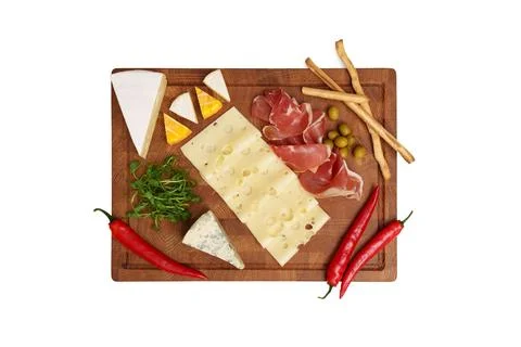 Cheese board isolated on white table. Different types of cheese, chili. Stock Photos