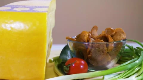 Cheese, bread crackers cherry tomatoes and greens Stock Footage 124374757