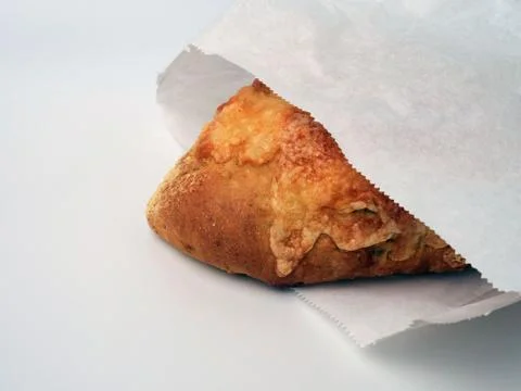 Cheese bread, packed in a paper bag, isolated on white Photos