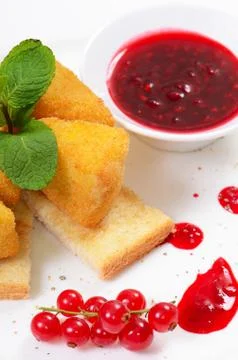 Cheese in breadcrumbs with currant jam Stock Photos