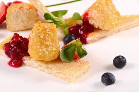 Cheese in breadcrumbs with currant jam Stock Photos