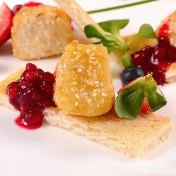 Cheese in breadcrumbs with currant jam Stock Photos