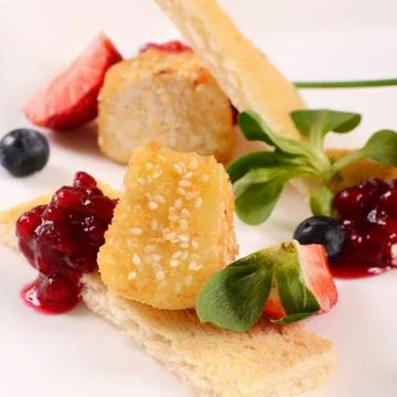 Cheese in breadcrumbs with currant jam Stock Photos