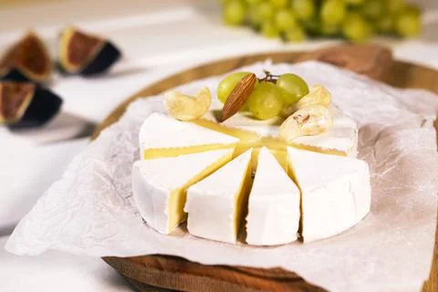 Cheese Brie type Camembert with fig nuts and grape on wooden baord, Healthy Stock Photos