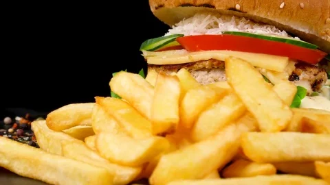 Cheese burger with fresh vegetables and Fried Potato wedges Stock Footage 84652116