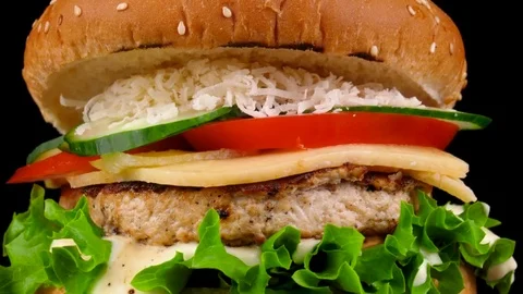 Cheese burger with fresh vegetables, camera moves from bottom to top Stock Footage 84653219