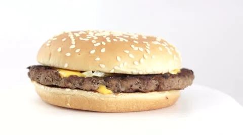 Cheese Burger rotating 360 degrees against white background Stock Footage 49875611