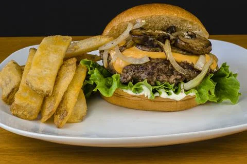 Cheese burger top onions and mushrooms Stock Photos