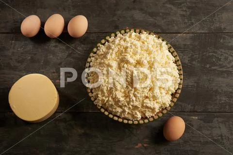 Cheese, butter and eggs on the wooden table Stock Photos
