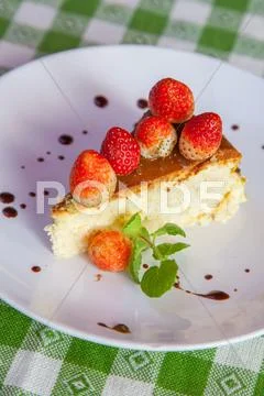 Cheese cake and ice-cream on plate with fruit topping. Stock Photos