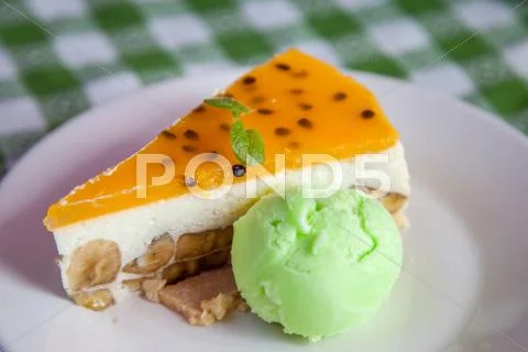 Cheese cake and ice-cream on plate with fruit topping. Stock Photos