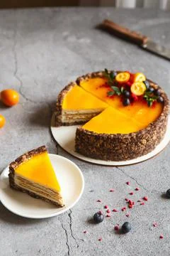 Cheese cake with mango fruit on a grey background. Cheese cake with passion f Stock Photos