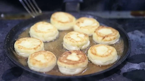 Cheese cakes fried in a pan Video stock 72744060