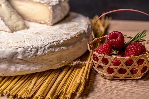 Cheese Camambert with raspberry basket. Rustic set on black backdrop. Healthy Stock Photos