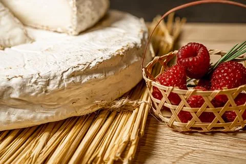 Cheese Camambert with raspberry basket. Rustic set on black backdrop. Healthy Stock Photos