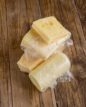 Cheese coated with plastic Stock Photos