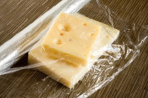 Cheese coated with plastic Stock-Fotos