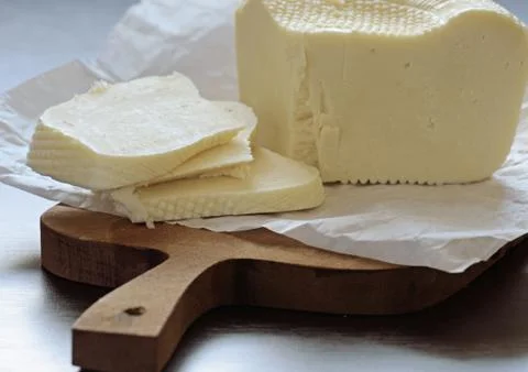 Cheese on a cutting board Stock Photos