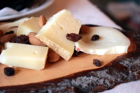 Cheese on cutting board Stock Photos