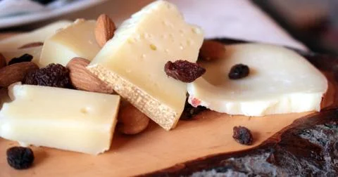 Cheese on cutting board Stock Photos