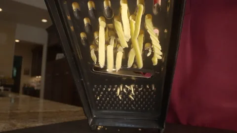Cheese falls under cheese grater slow motion macro Stock Footage 221433845