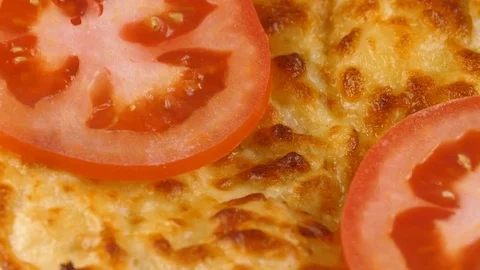 Cheese-filled bread with sliced tomatoes on top, close-up view Stock Footage 83160005