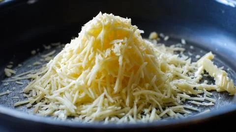 Cheese on frying pan Stock Photos